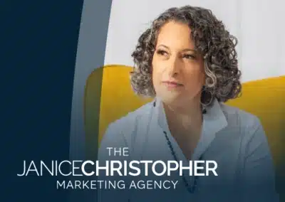 Woman with curly hair, seated in marketing agency setting.