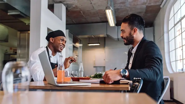 Franchise owner talking to chef