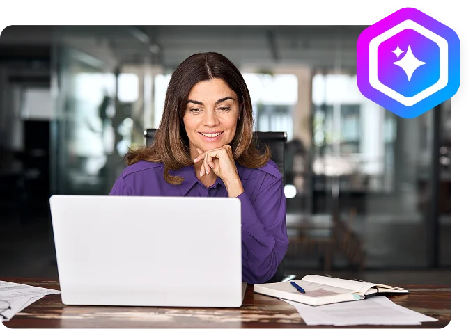 woman sitting at a table with her laptop open